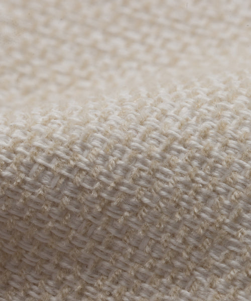 Close-up of the Fabric Swatch Performance Ivory showcases its textured weave and detailed fibers—an ideal choice for enhancing outdoor furniture pieces.
