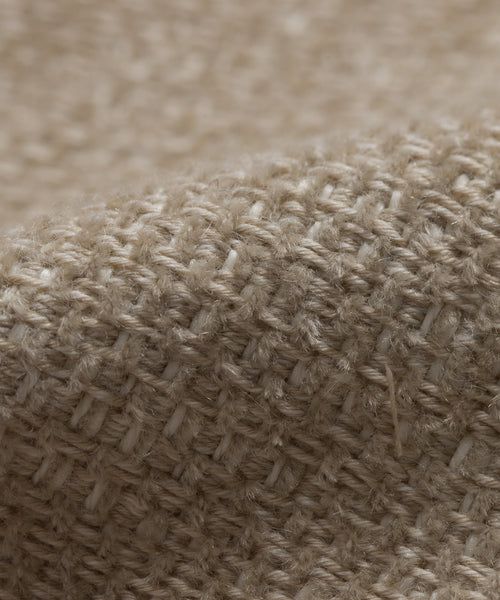 Close-up of the Fabric Swatch Performance Natural, showcasing its textured, grid-like pattern and visible fibers with a gentle fold—perfect for pairing with the Outdoor Brentwood Chair or Ottoman.