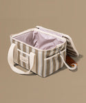 Striped cooler bag with a handle on a beige background