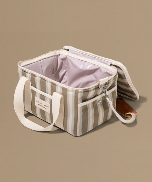 Striped cooler bag with a handle on a beige background