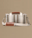 Striped bag with brown accents on a beige background