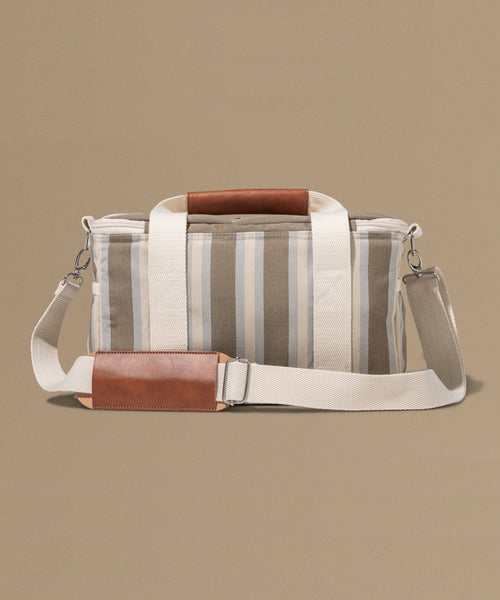 Striped bag with brown accents on a beige background