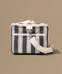 Striped bag with a white strap on a beige background