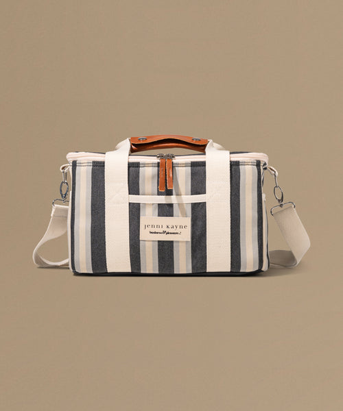 Striped bag with a visible brand label on a beige background