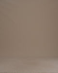 Thumbnail for video: A woman wearing a pleated skirt against a plain beige studio background.