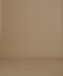 Thumbnail for video: A woman stands against a plain beige studio background wearing a white short-sleeve T-shirt, brown cropped pants, and dark brown slip-on shoes.
