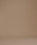Thumbnail for video: A woman modeling a black short-sleeve crewneck t-shirt paired with light beige pants, set against a solid warm brown studio background.