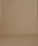 Thumbnail for video: A close-up of a person wearing a dark brown crew-neck knit sweater, paired with a pleated dark skirt, against a solid beige background.