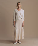 Thumbnail for video: Model wearing pleated skirt in ivory.