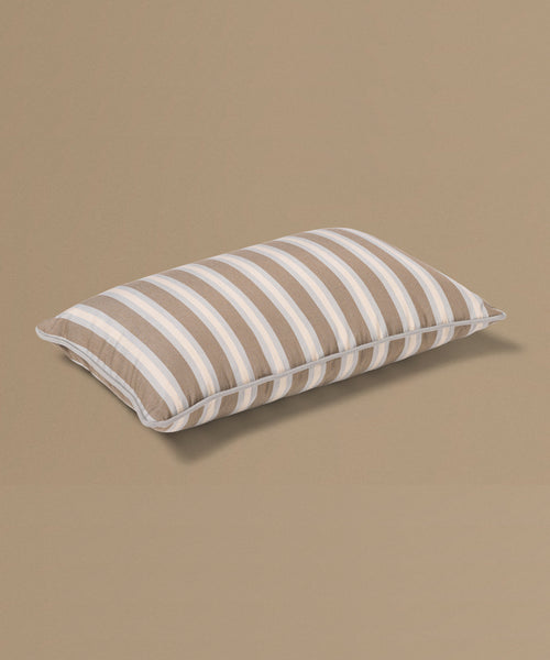 Striped pillow on a beige background