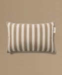 Striped pillow with a label on a beige background