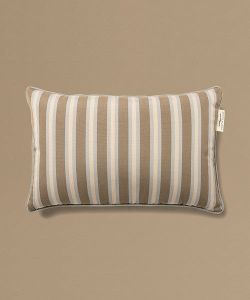Striped pillow with a label on a beige background