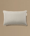 Gray pillow with a label on a beige background
