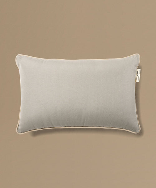 Gray pillow with a label on a beige background