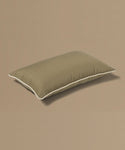 Brown pillow with a brand tag on a beige background