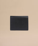 The Reece Leather Wallet is a mid-size black accessory crafted from textured leather with a subtle lizard skin pattern, shown on a plain beige background.