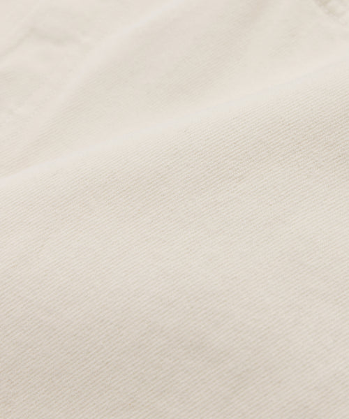 Close-up view of the Ren jean, featuring an off-white fabric with a subtle diagonal ribbed texture that suggests a soft, smooth material.