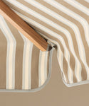Striped patio umbrella on a beige background