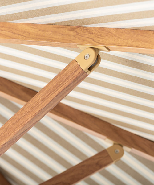 Striped patio umbrella on a beige background