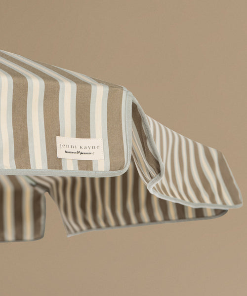 Striped patio umbrella on a beige background