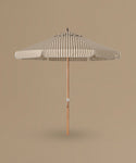 Striped patio umbrella on a beige background