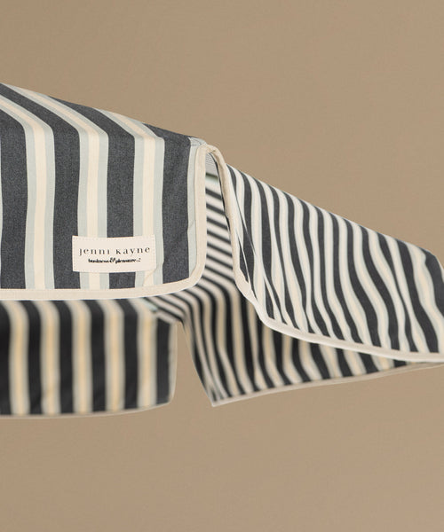 Striped fabric with a visible brand label on a beige background