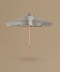 Striped patio umbrella on a beige background
