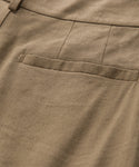 Close-up of the Riley Trouser in light brown linen, featuring a neatly stitched seam and pocket. Its lightweight fabric offers airy comfort, making it perfect for summer wear.