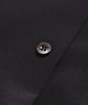 Close-up of a single black button sewn onto the Silk Sloane Shirt, featuring textured black fabric and a relaxed fit.