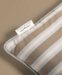 Striped pillow on a beige background