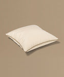 Beige pillow with a tag on a beige background
