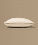 Beige pillow with a tag on a beige background