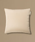 Beige pillow with a tag on a beige background