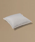Light gray pillow on a beige background
