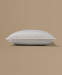 Light gray pillow on a beige background