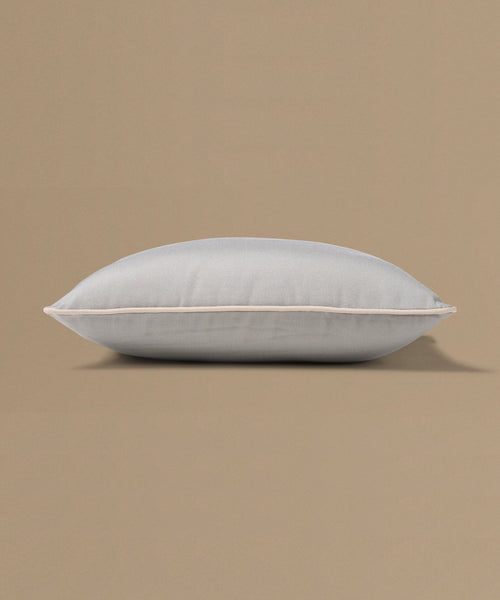 Light gray pillow on a beige background