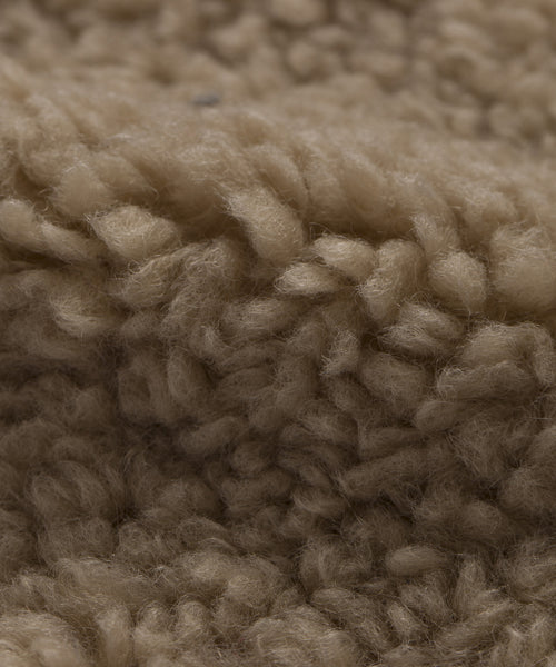 Close-up of the Fabric Swatch Oatmeal Sherpa, featuring textured beige, curly, and soft fibers—ideal for a cozy feel on your Aspen Sofa or Aspen Chair.