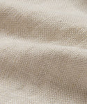 A close-up of the Fabric Swatch Drift Linen highlights its beige, boucle-style surface with soft texture, small looped yarns, and a subtly wavy appearance.