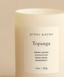 The Topanga Glass Candle by jenni kayne is a 10 oz white candle in a frosted jar, hand-poured in Los Angeles with natural scents of green leaves, eucalyptus, moss wood, and grapefruit.