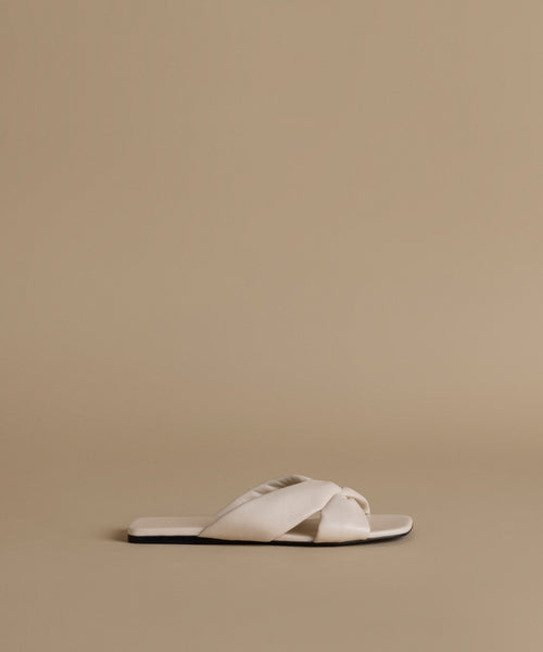 White sandal on a beige background