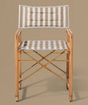 Wooden director's chair with striped cushions on a beige background