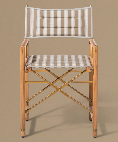Wooden director's chair with striped cushions on a beige background