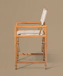 Wooden chair with white cushion on a beige background