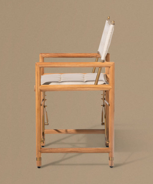 Wooden chair with white cushion on a beige background