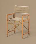 Foldable chair with wooden frame and beige cushion on a brown background