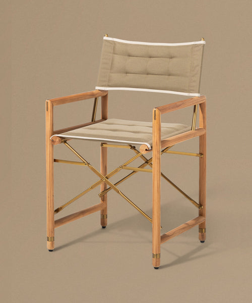 Foldable chair with wooden frame and beige cushion on a brown background