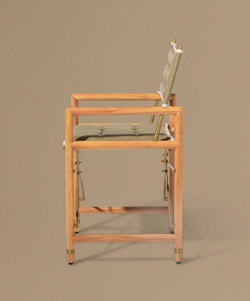 Foldable chair with wooden frame and beige cushion on a brown background