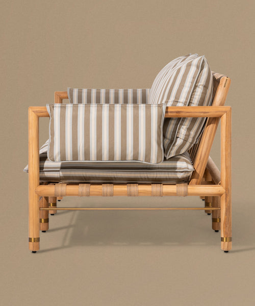 Wooden sofa with striped cushions on a beige background