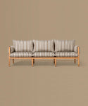 Wooden sofa with striped cushions on a beige background
