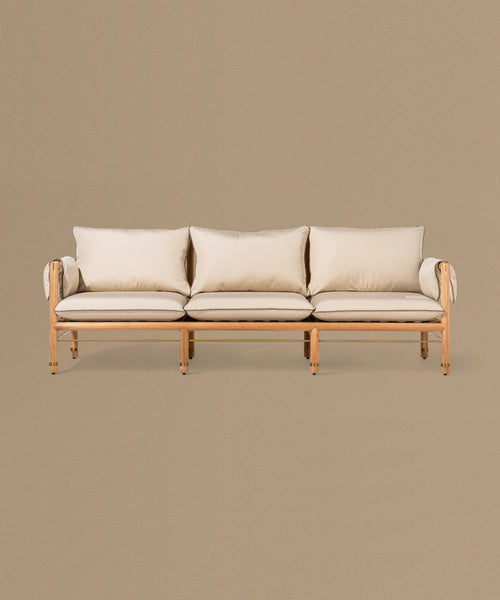 Beige sofa with wooden frame on a beige background